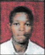 Passport-style portrait photo of a young man in a white shirt against a red background