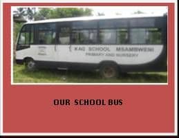 White KAG School minibus parked on grass