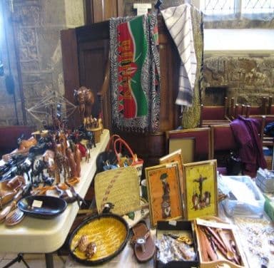 A stall of African carvings, baskets, sandals and kanga cloth