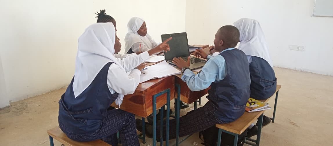 Learners working on laptops