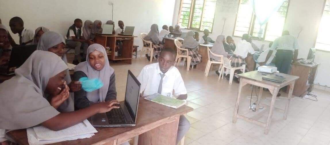 Learners working on laptops in the computer lab