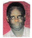 Passport-style portrait photo of a man against a pink background