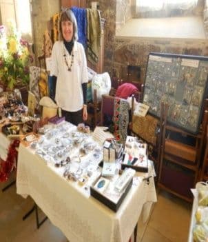 A woman at a stall of African jewellery and crafts
