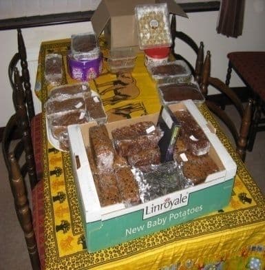 A box of home-baked cakes and loaves on a table