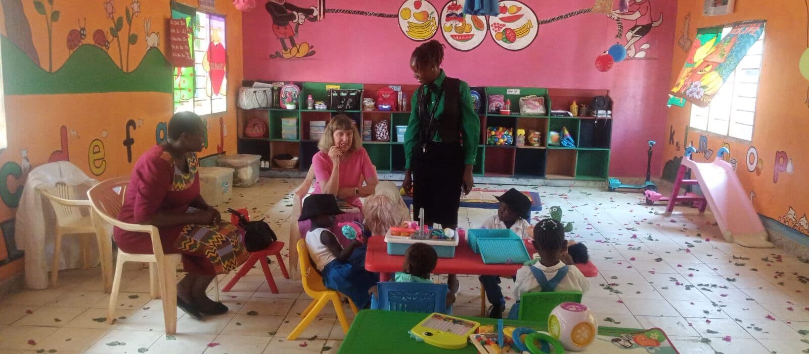 Daycare classroom with a carer and children