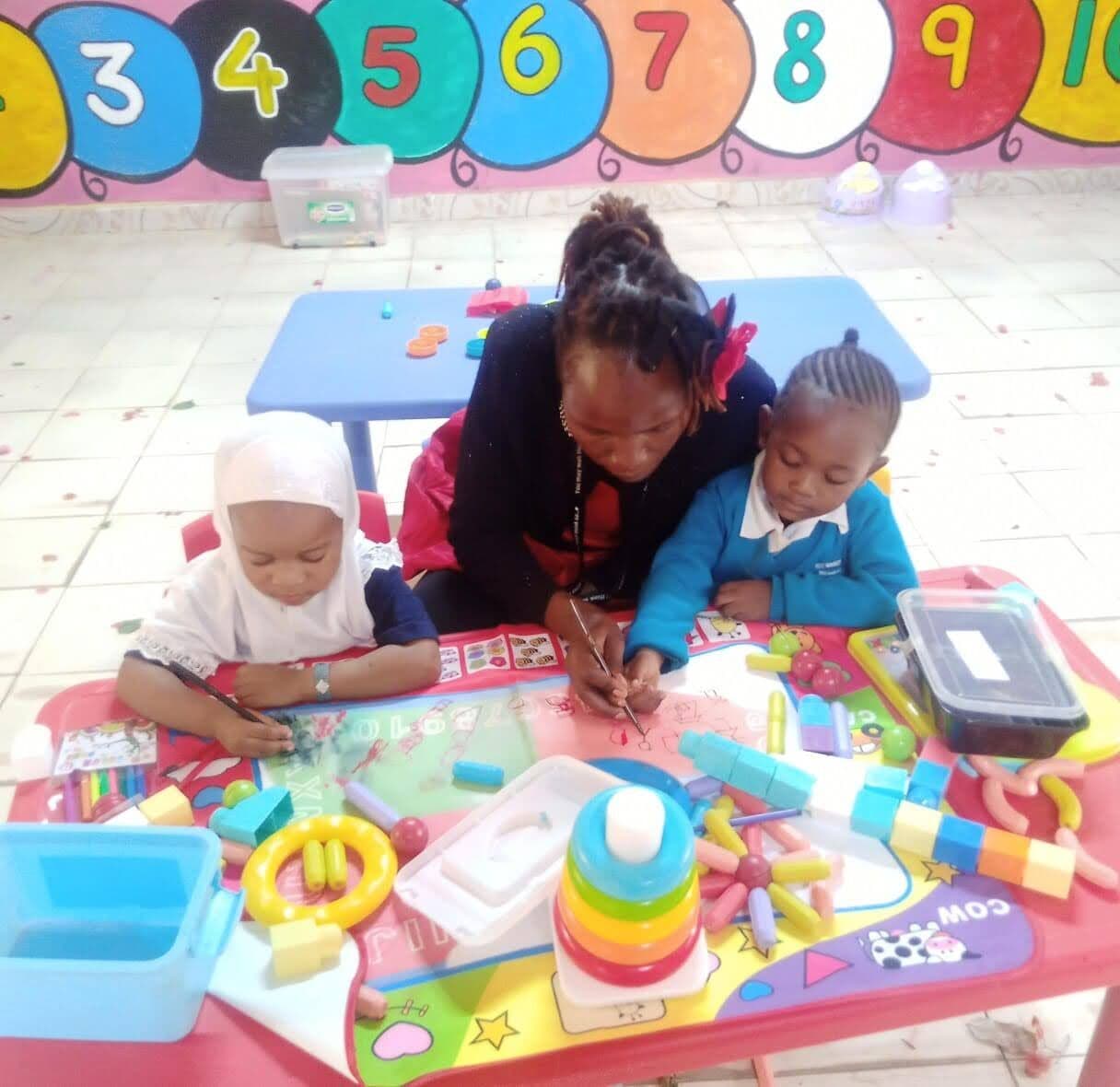 A daycare teacher playing with toddlers