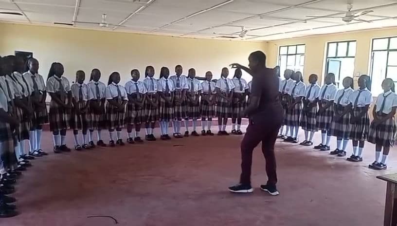 Learners singing together in the hall