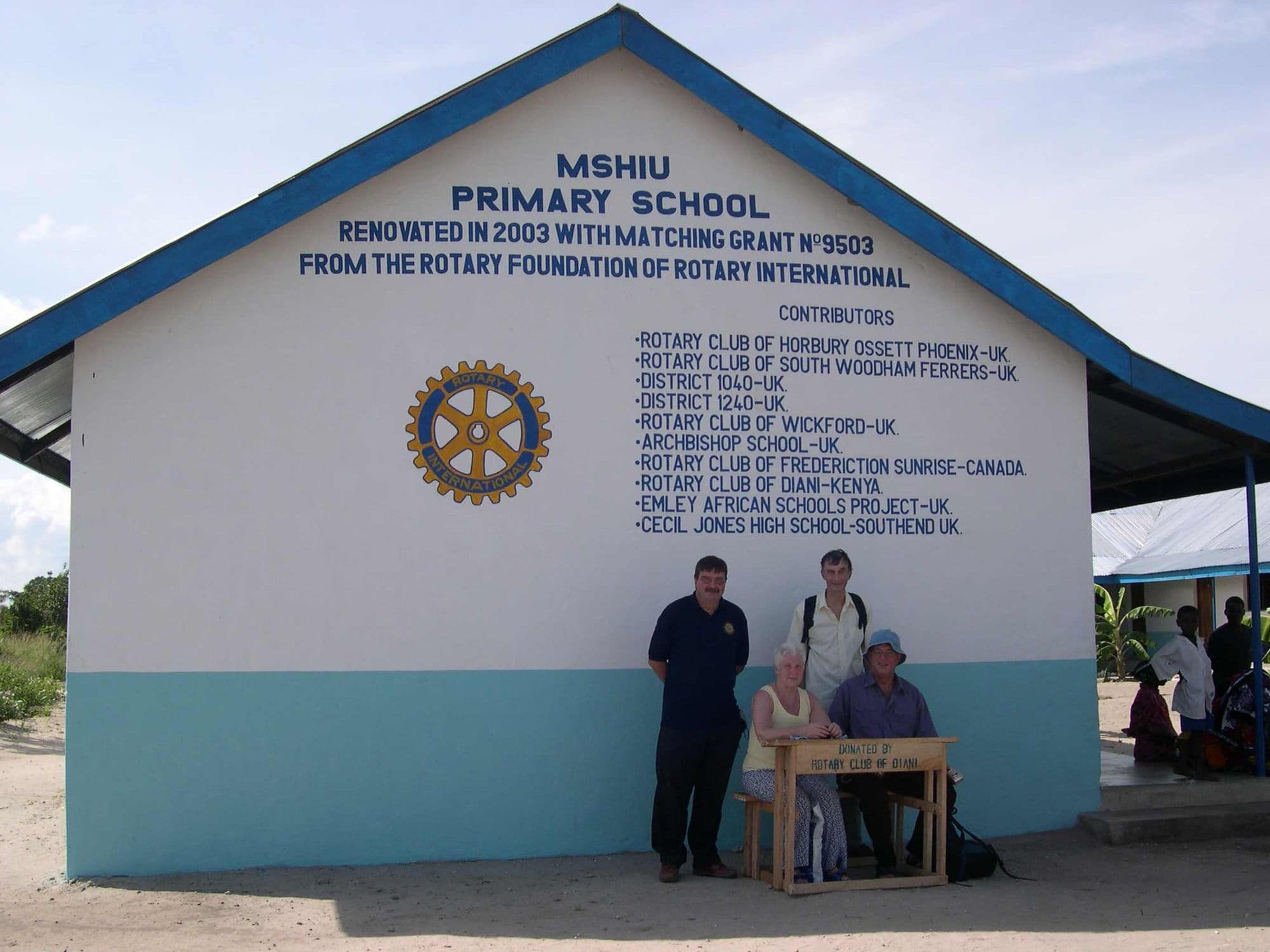 Visitors outside Mshiu Primary School, renovated in 2003 with a Rotary Foundation matching grant