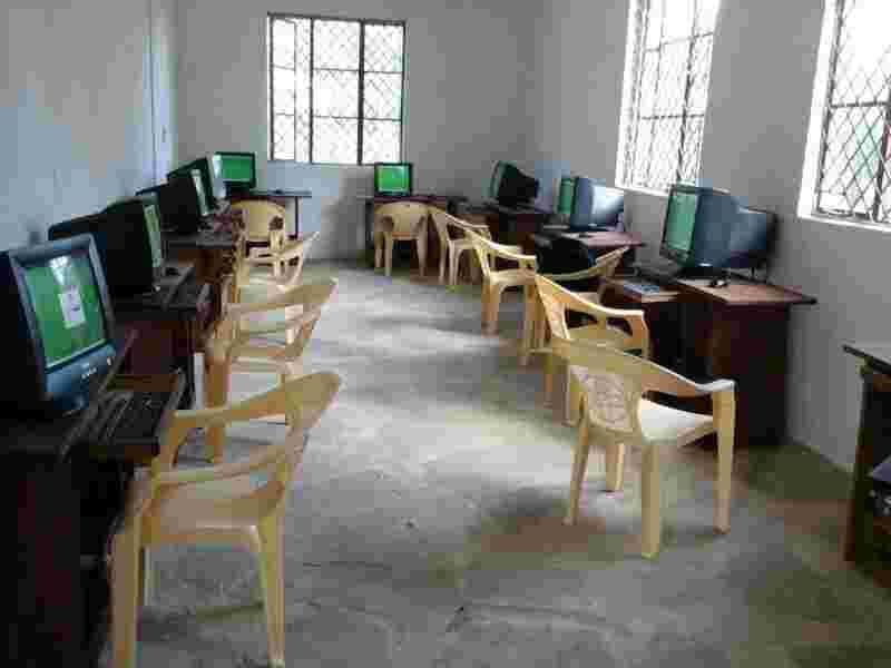 Rows of refurbished computers on desks in the new computer room