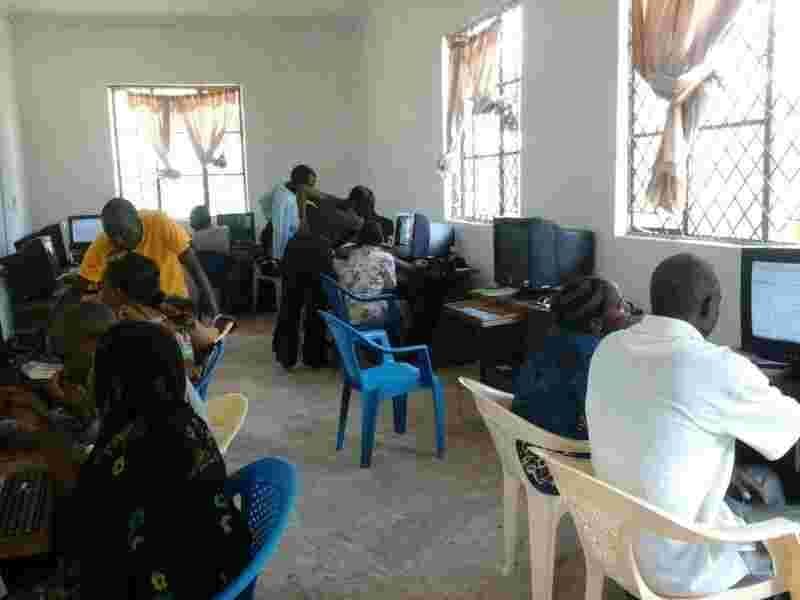 Teachers being trained at the computers