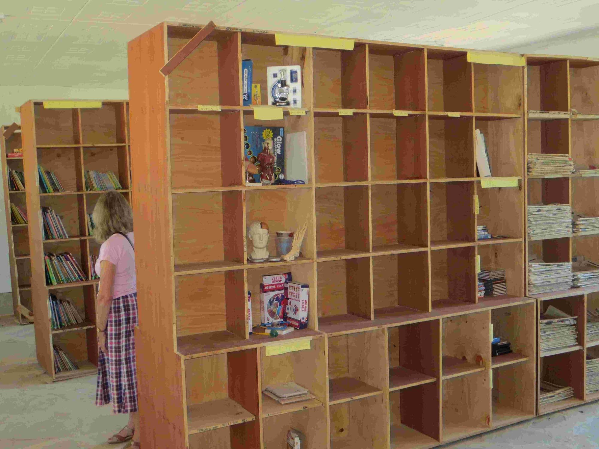 Tall wooden shelving units filling the library