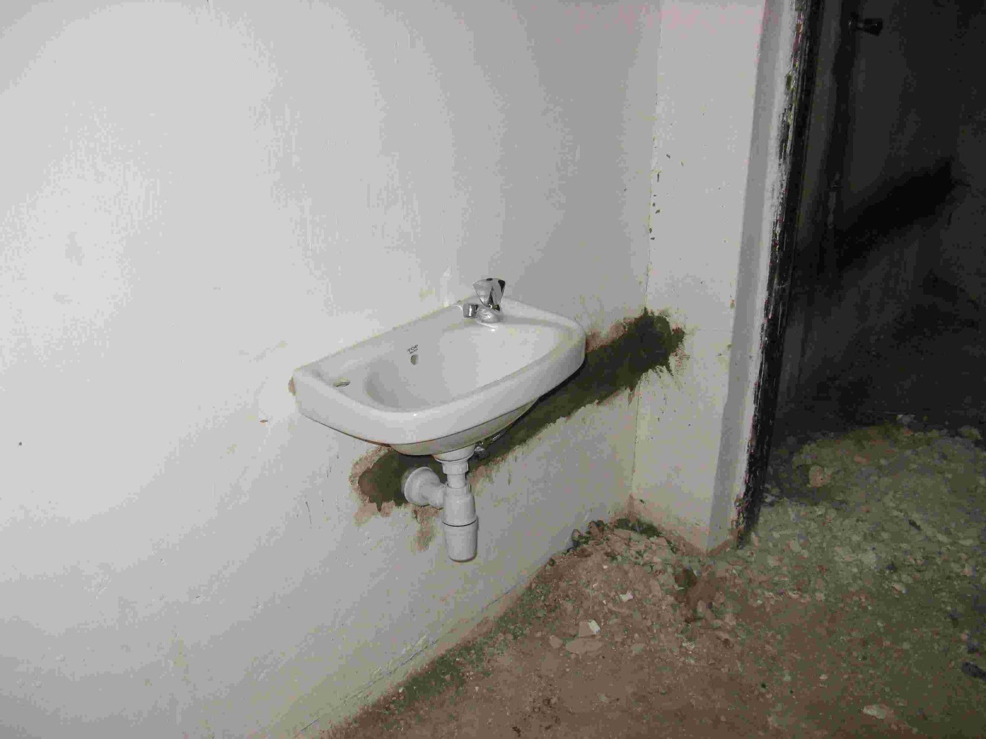 A newly fitted washbasin on a wall in the library toilets