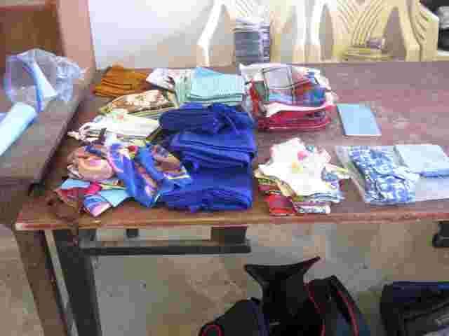 Fabric, flannels and sewing materials for reusable sanitary kits laid out on a table