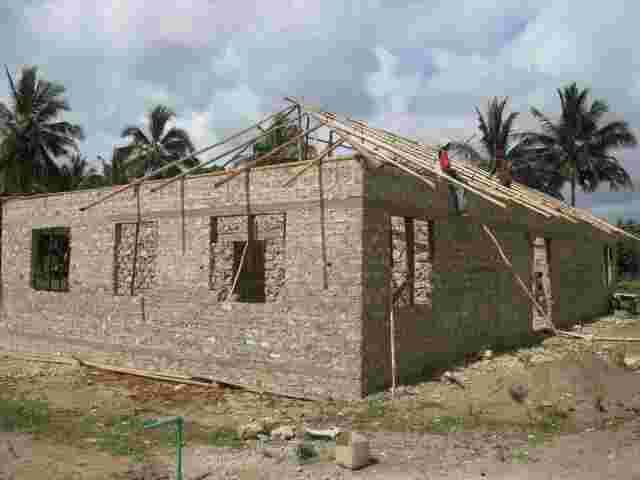 The first accommodation block at the orphanage with walls up and roof timbers going on