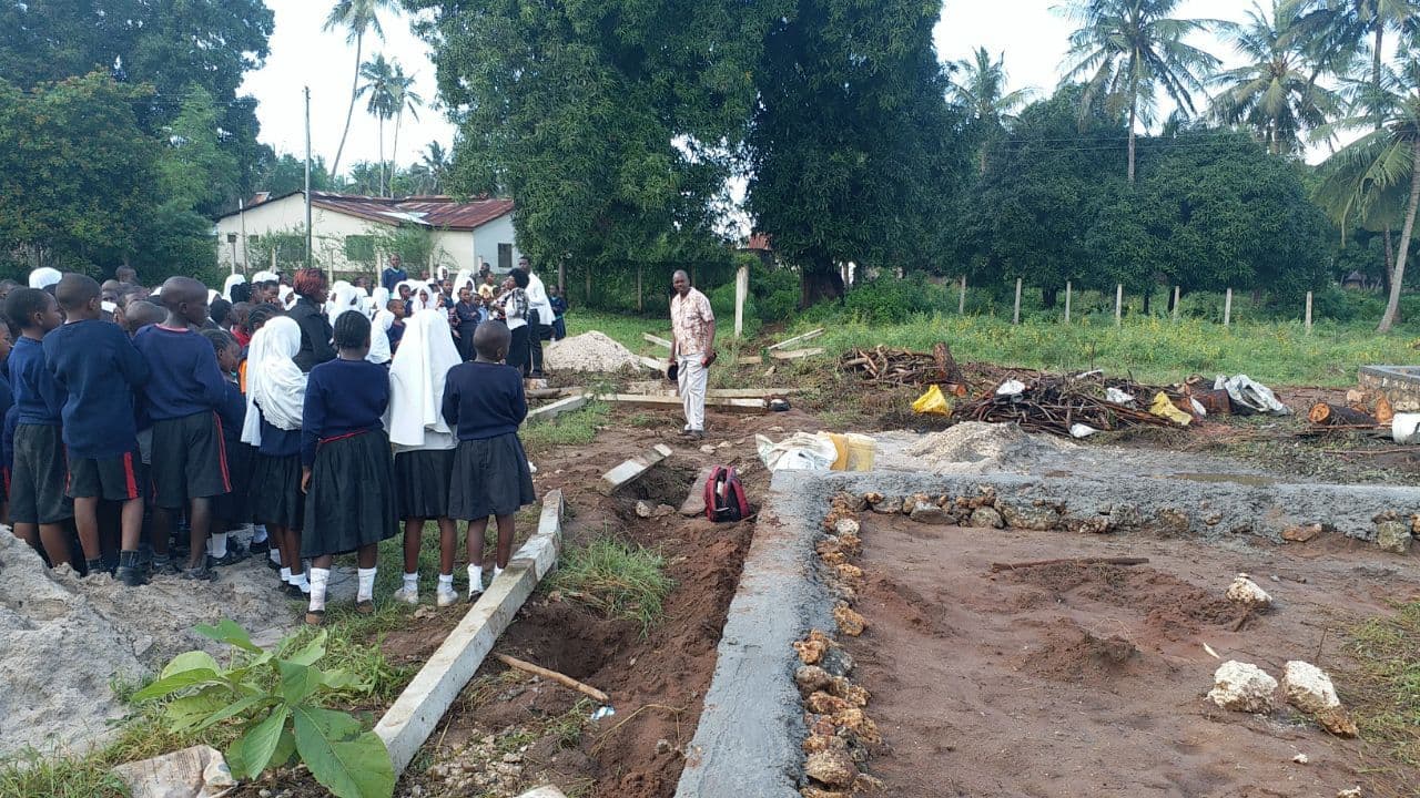 Pupils and teachers gathered by the foundations of the new nursery on the primary site