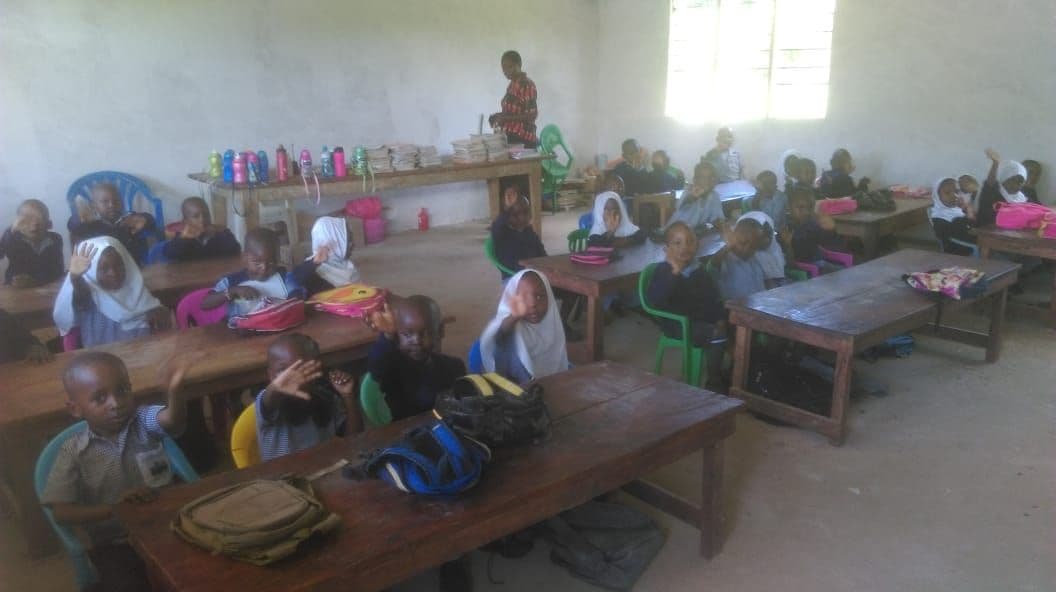 Young pupils at desks in a new nursery classroom