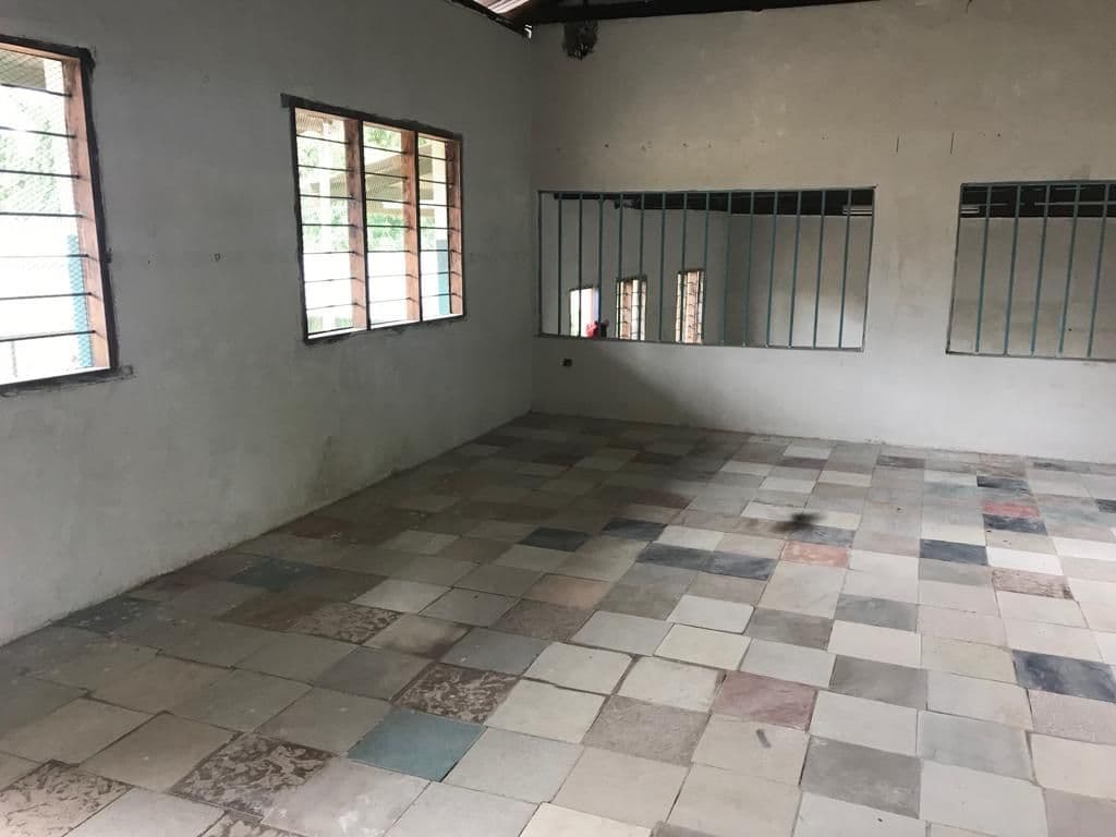 An empty former nursery classroom with a tiled floor, being adapted for boarders