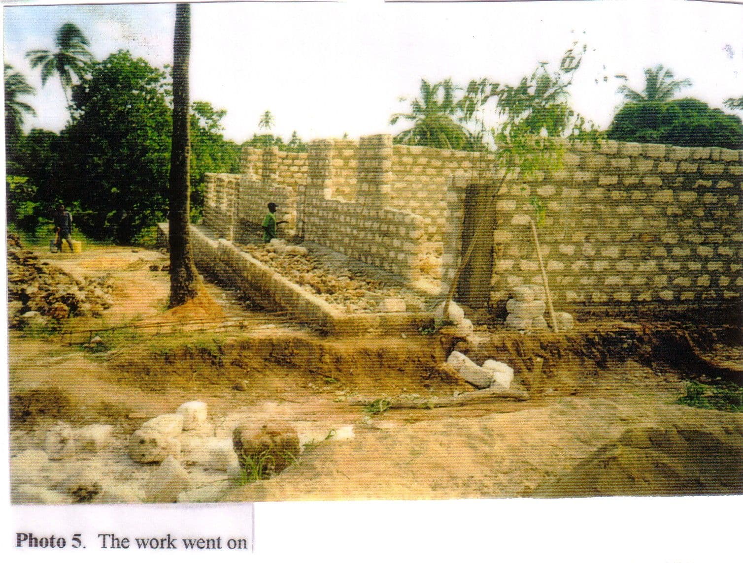 Scanned print of the first block walls of the nursery school rising on the building site