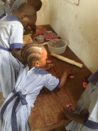 Young children playing with play dough at a low table
