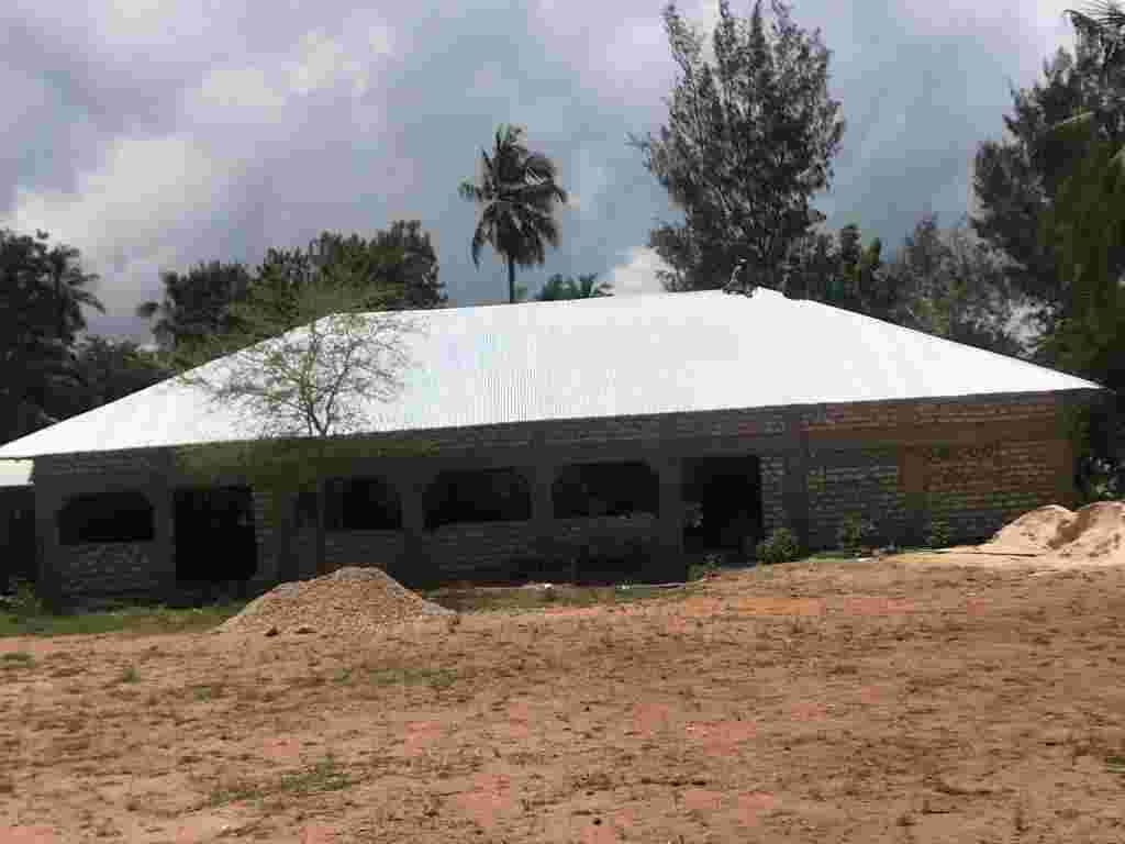 The new dining room building with walls up and roof on