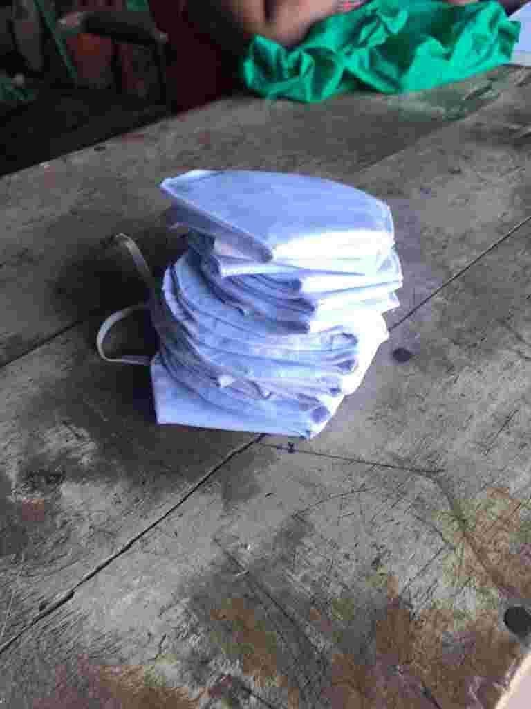 A stack of cloth face masks on a desk