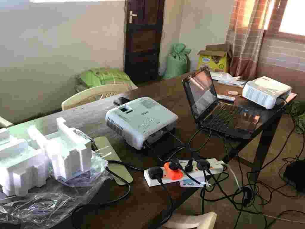 A new projector connected to a laptop on a classroom table