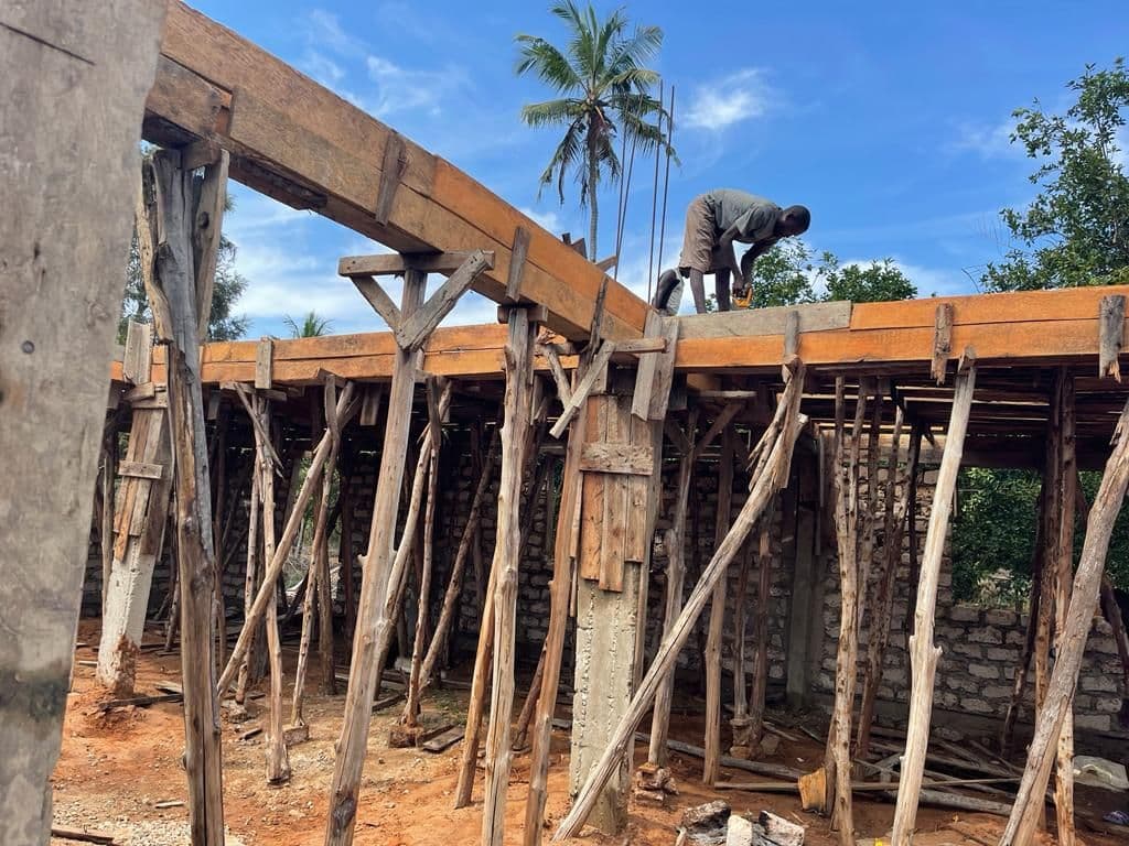 Wooden poles propping up the formwork for a concrete roof slab on the new lab building