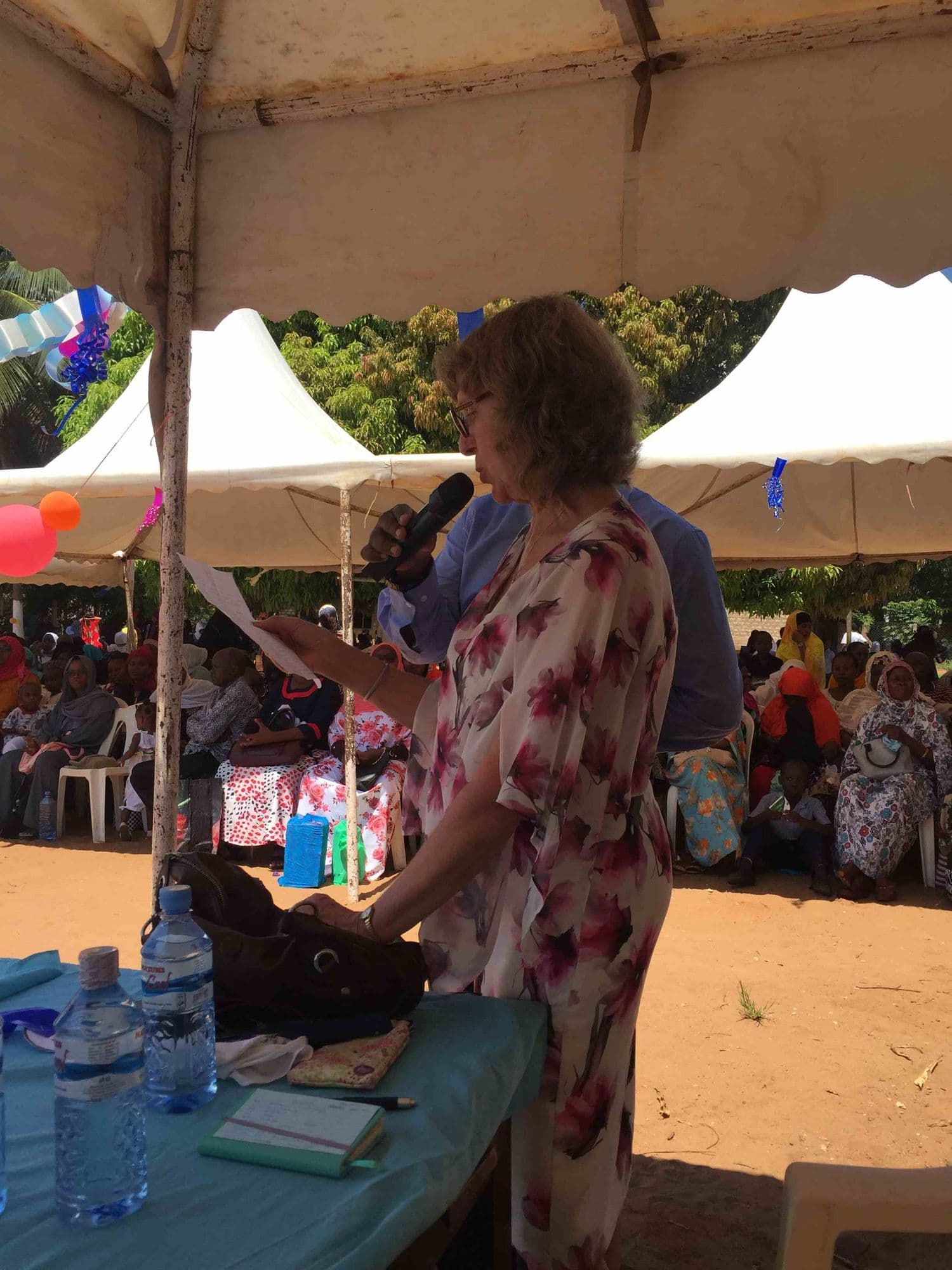 A visitor giving a speech under a marquee at graduation