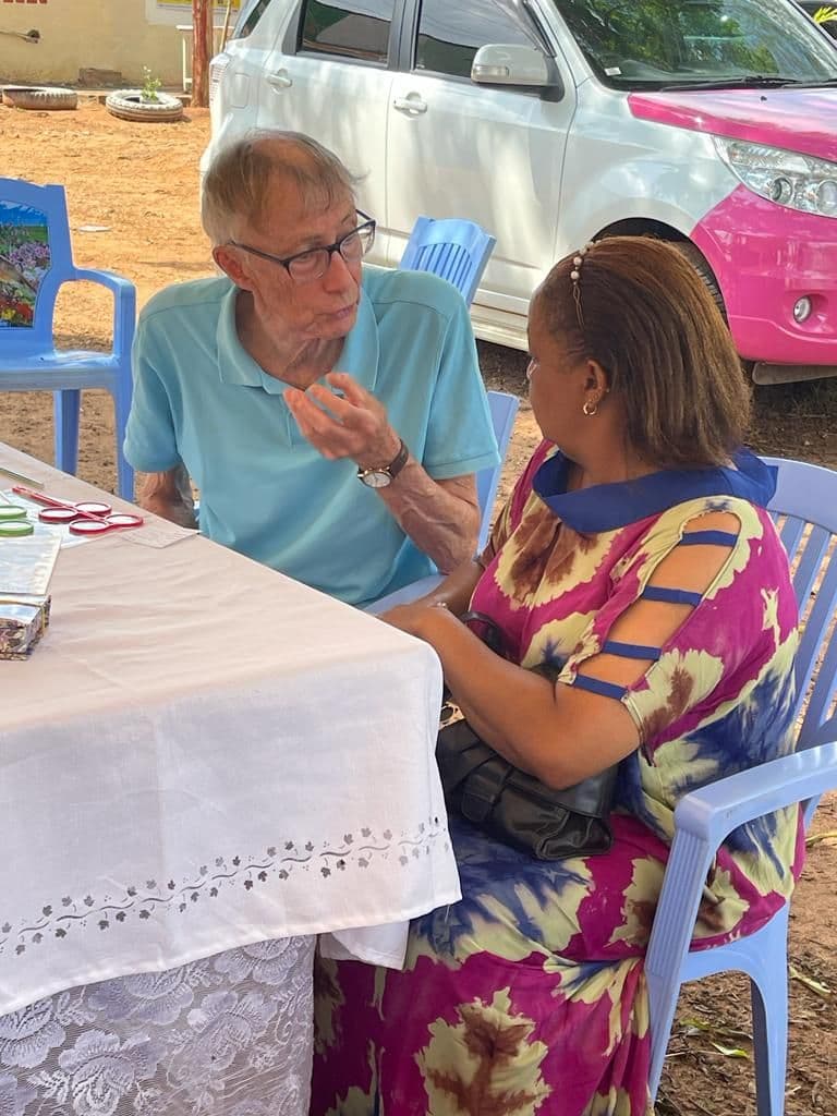 A visitor testing a woman's eyesight at a table at the health day