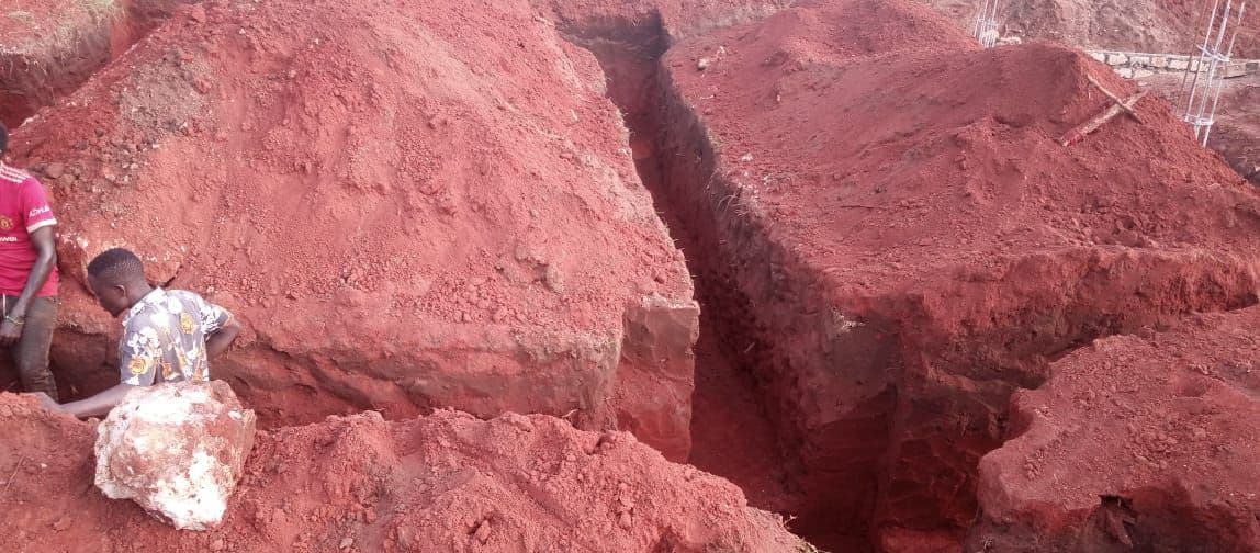 Deep foundation trenches dug into red earth for the secondary classrooms