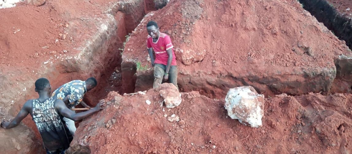Workers digging the foundation trenches down to the coral bed