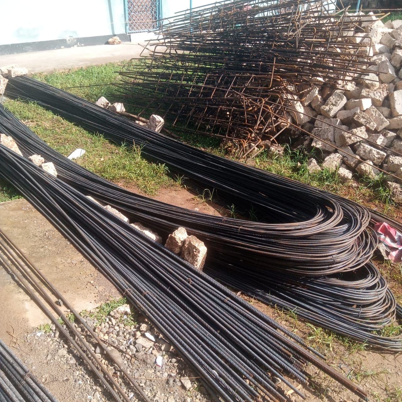 Bundles of steel reinforcing bars and wire on the ground