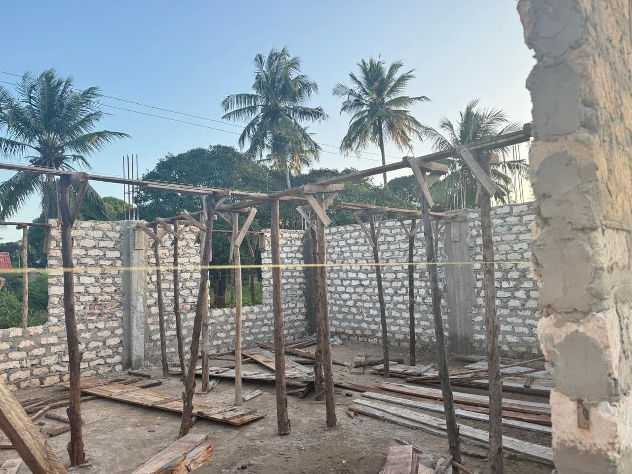 Timber props standing inside the new block walls ready for the roof slab