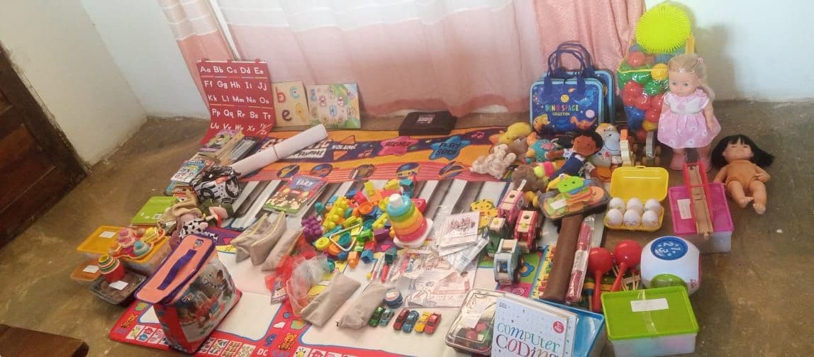 New toys, dolls and books spread out on the floor