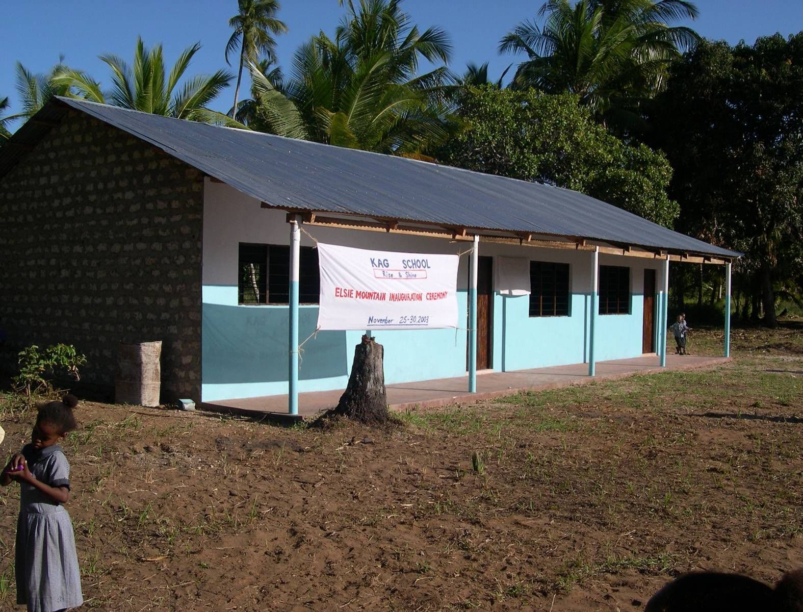 A single-storey classroom block with a banner across the verandah