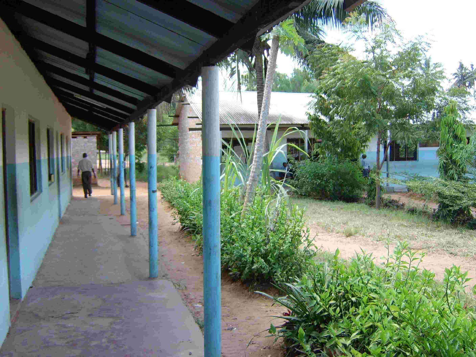 A covered walkway running along a row of school buildings