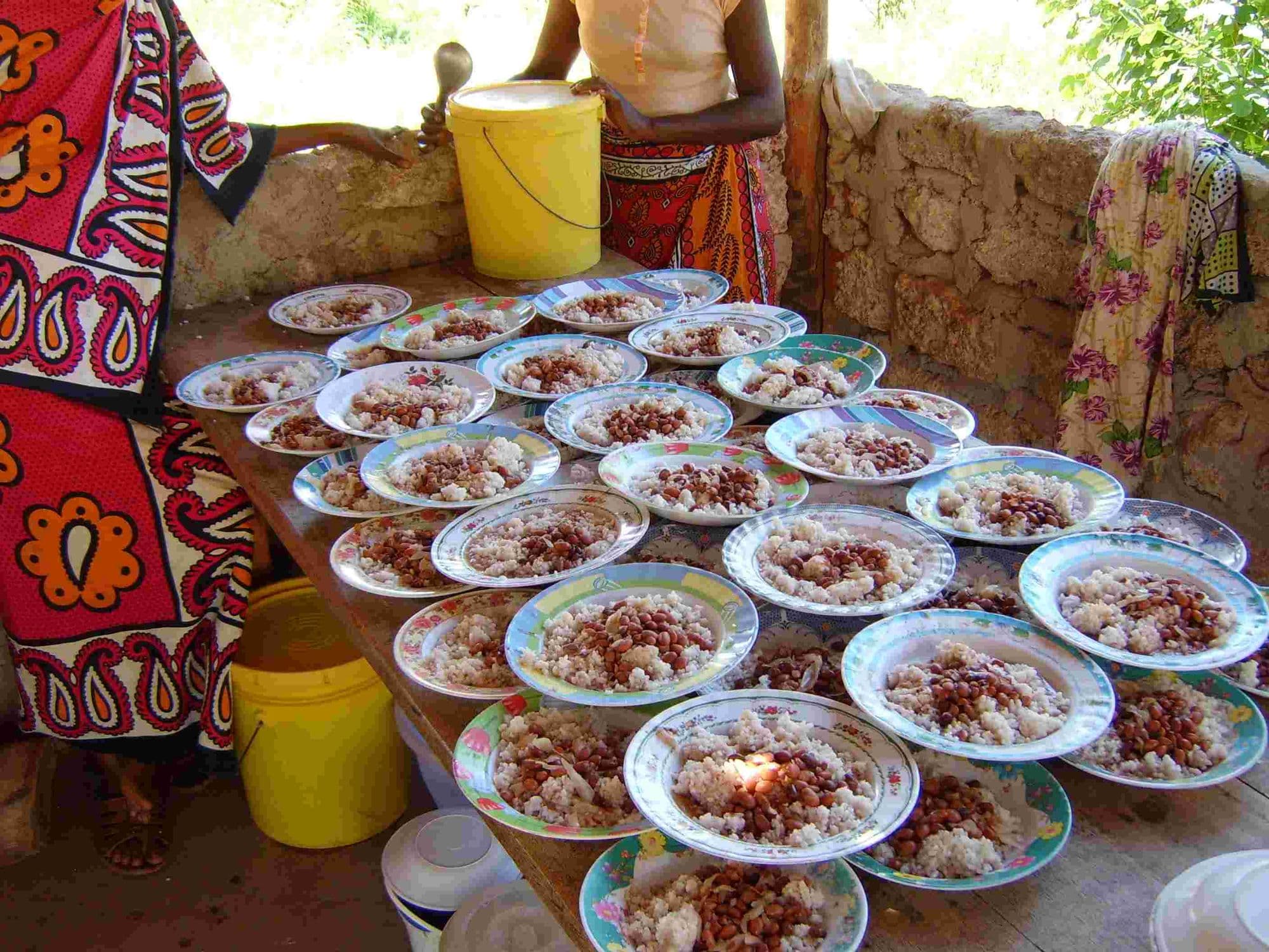 Plates of rice and beans laid out on a table ready for a meal